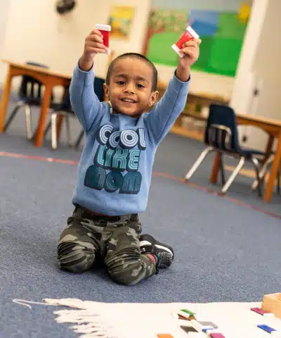 Montessori Boy Holding His Hands Up