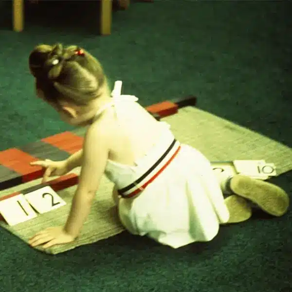 Montessori girl on the floor with a puzzle