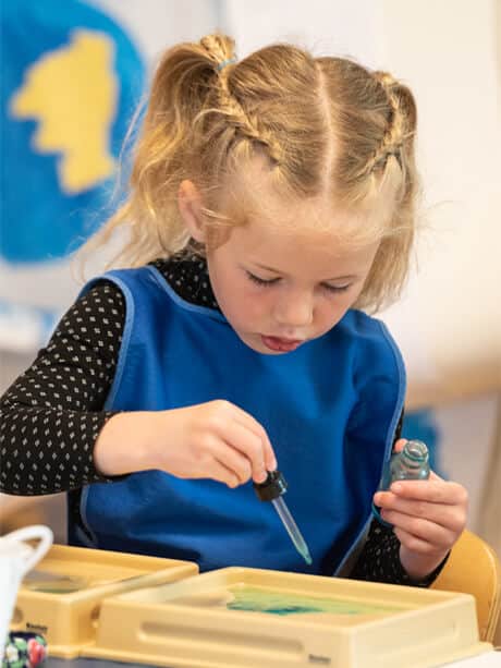 Montessori girl working at desk